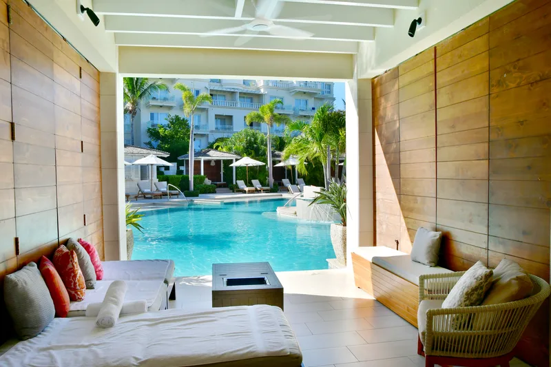 A poolside cabana with sofas