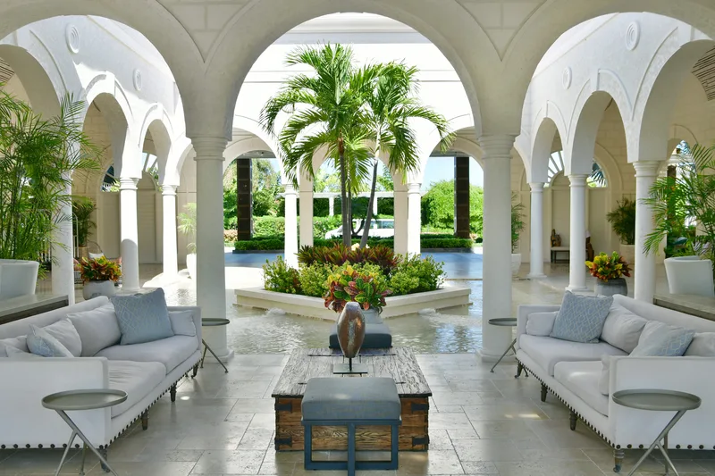 A lounge under the resort's arcades, palms in the courtyard