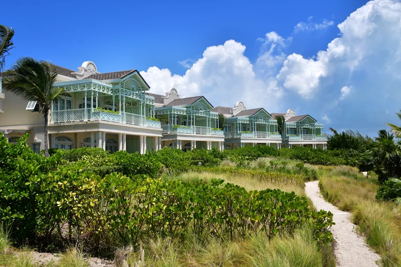 The villas seen from the dunes, under a Caribbean sky