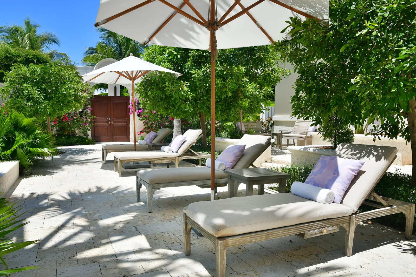 Loungers under a parasol in the courtyard