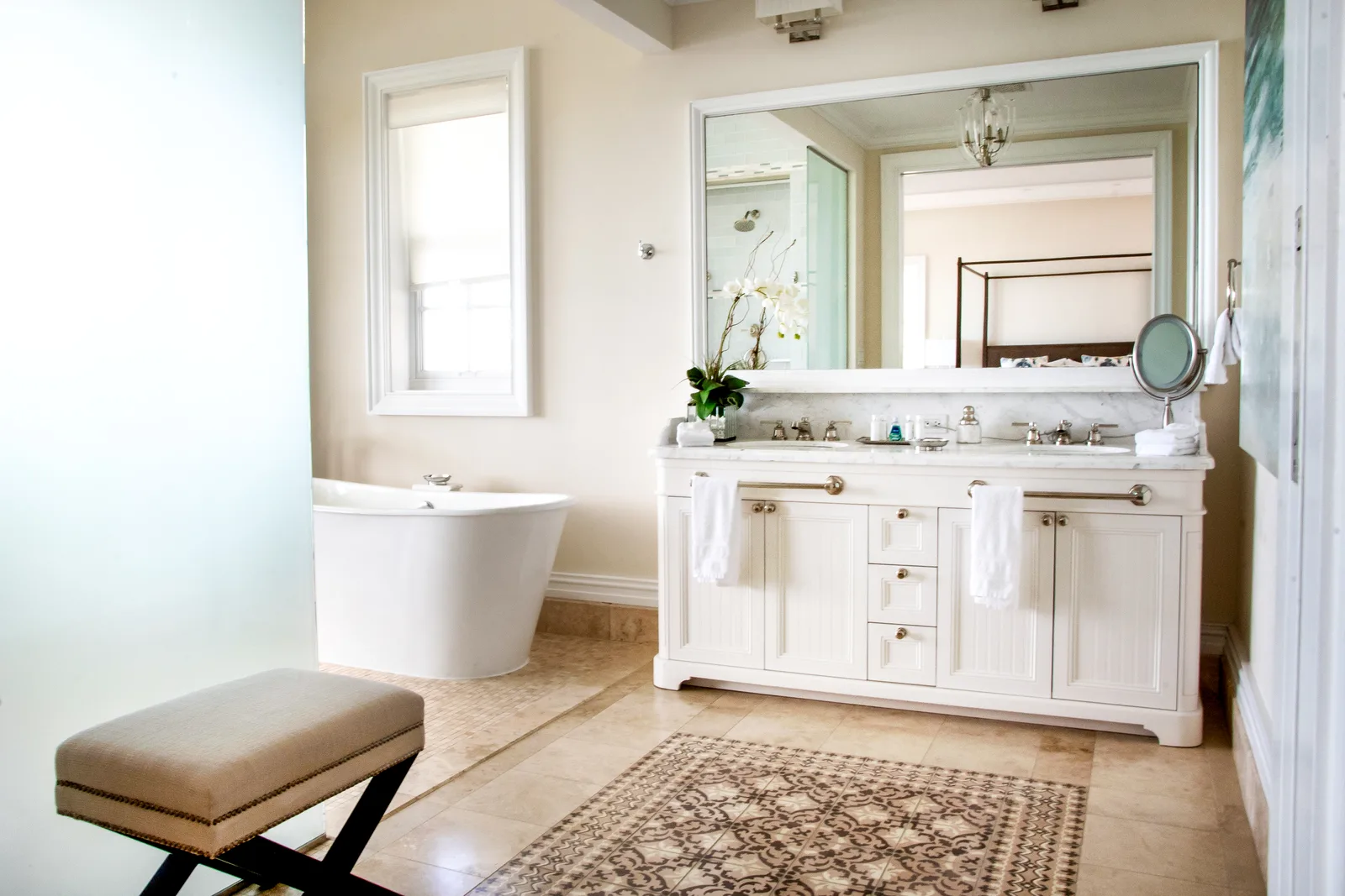 A bathroom with a freestanding tub and double vanity