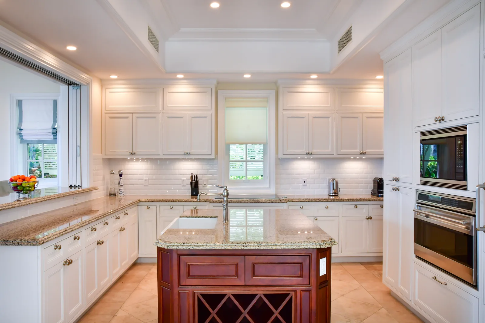 The kitchen: white cabinetry, a large island and professional appliances