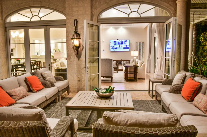 The covered lounge at dusk, opening onto the living room