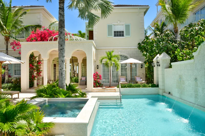 The private infinity pool of Villa One, with the house and its palms behind