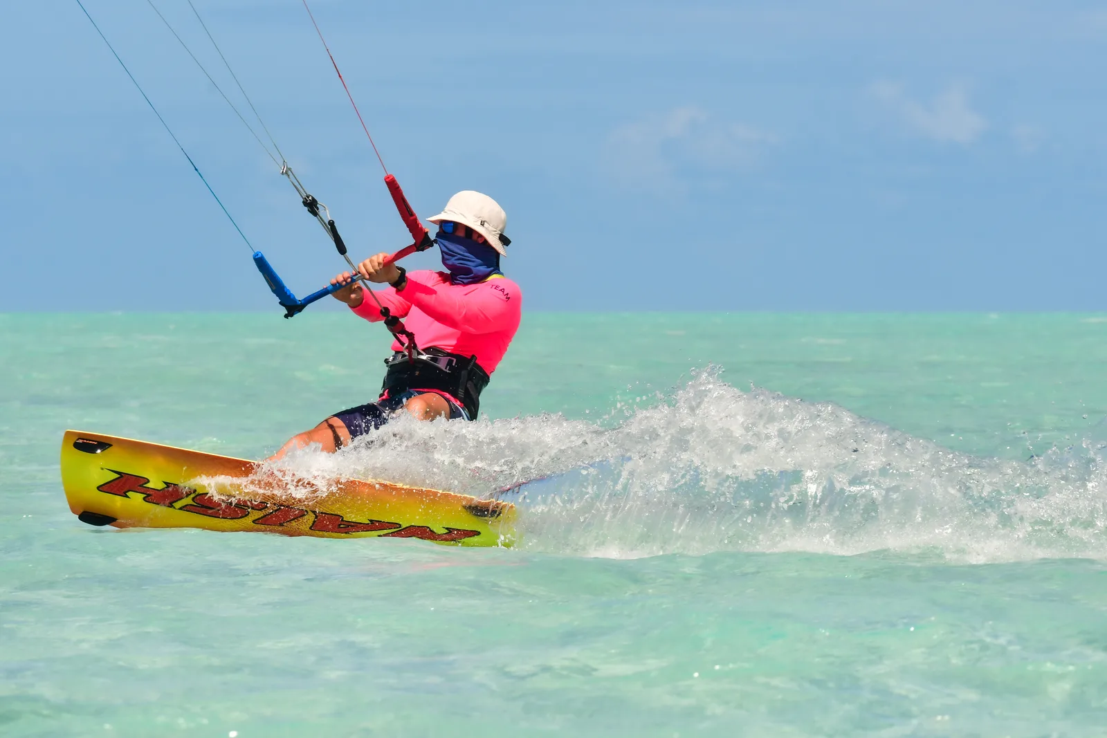 A kitesurfer on the flat water of Long Bay